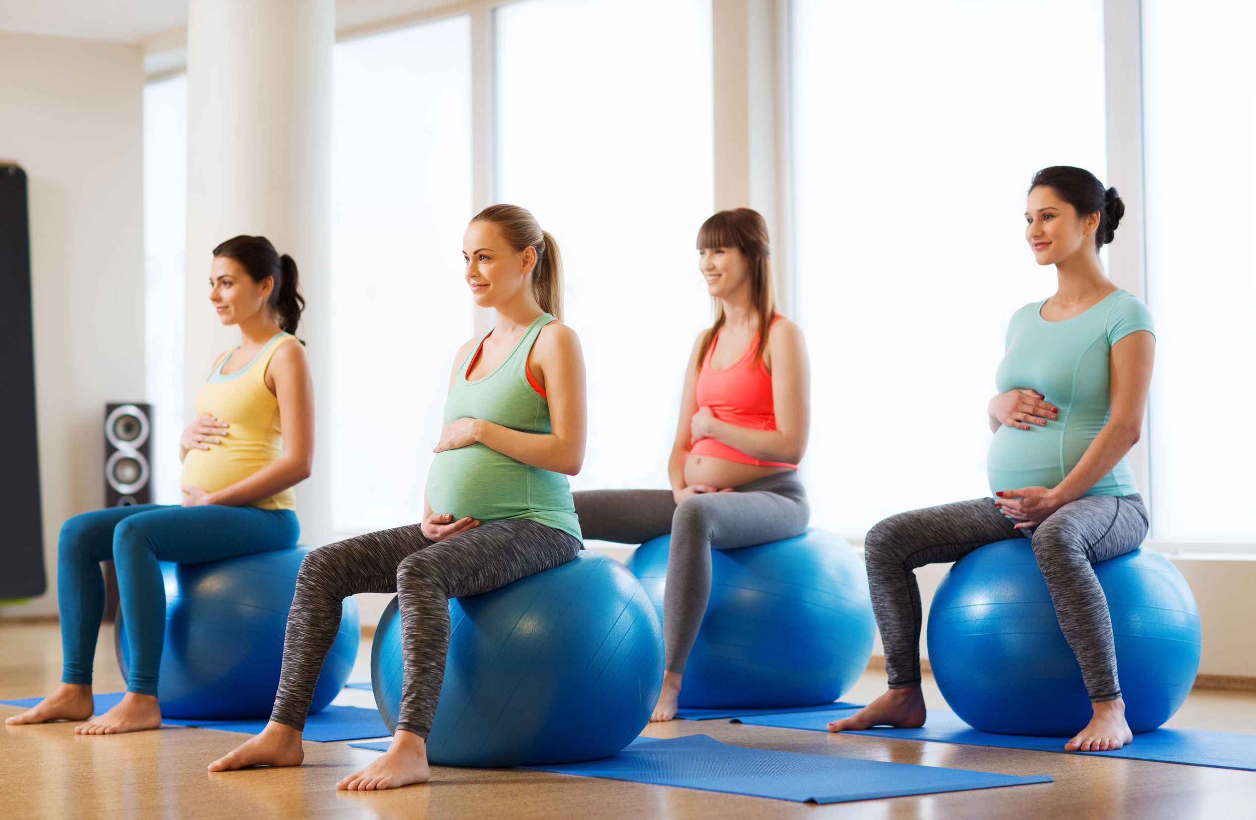 Happy pregnant women exercising